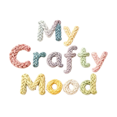 Text 'My Crafty Mood' made of knitted yarn in pastel colors on a white background